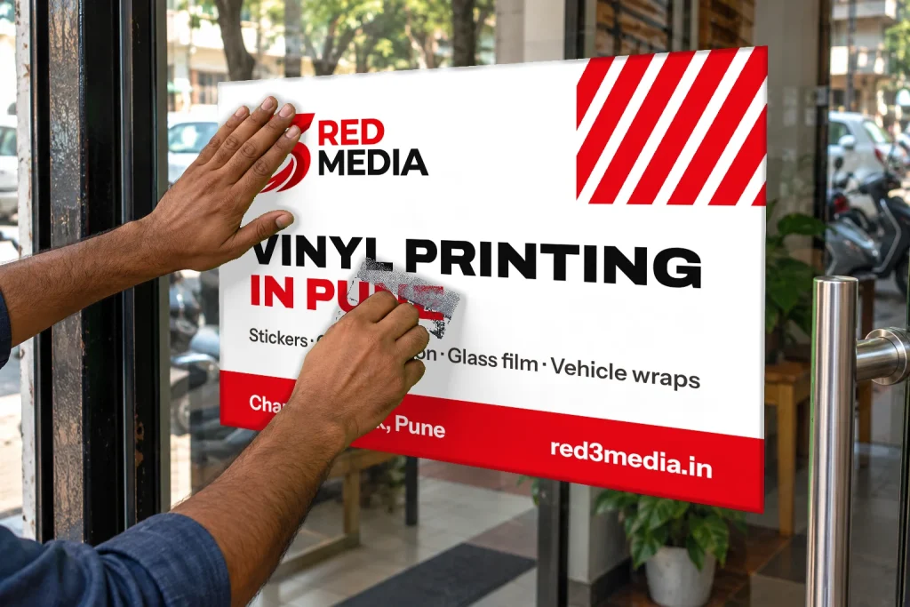 Applying a printed vinyl graphic on glass with a squeegee