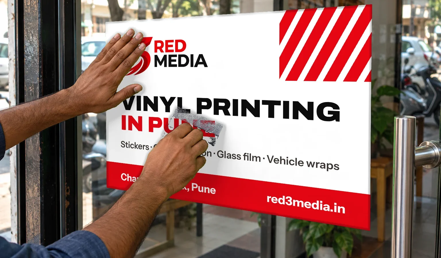 Applying a printed vinyl graphic on glass with a squeegee