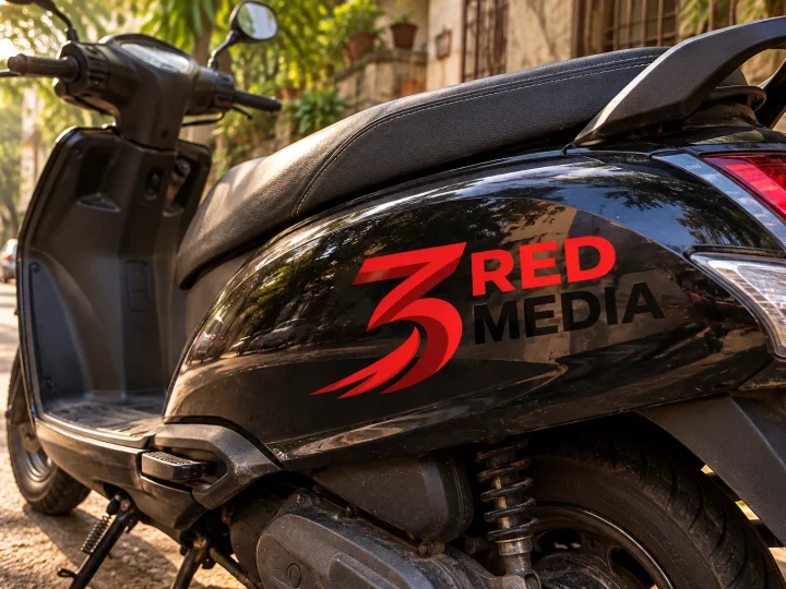 Scooter with cut vinyl graphics of the 3 Red Media logo
