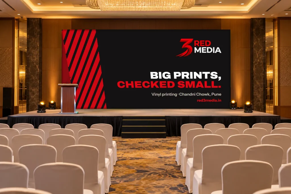 Stage backdrop printed for an event, carrying a 3 Red Media design