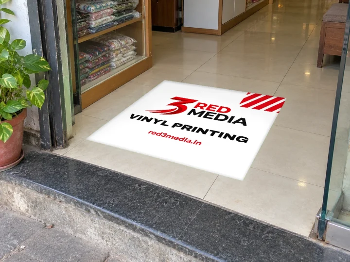 Anti-skid floor vinyl with the 3 Red Media logo at a store entrance