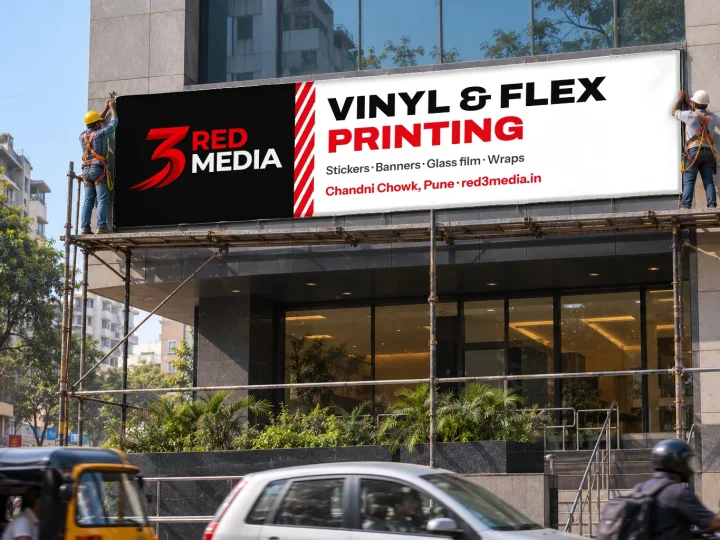 Installers fixing a printed flex banner on a building facade in Pune