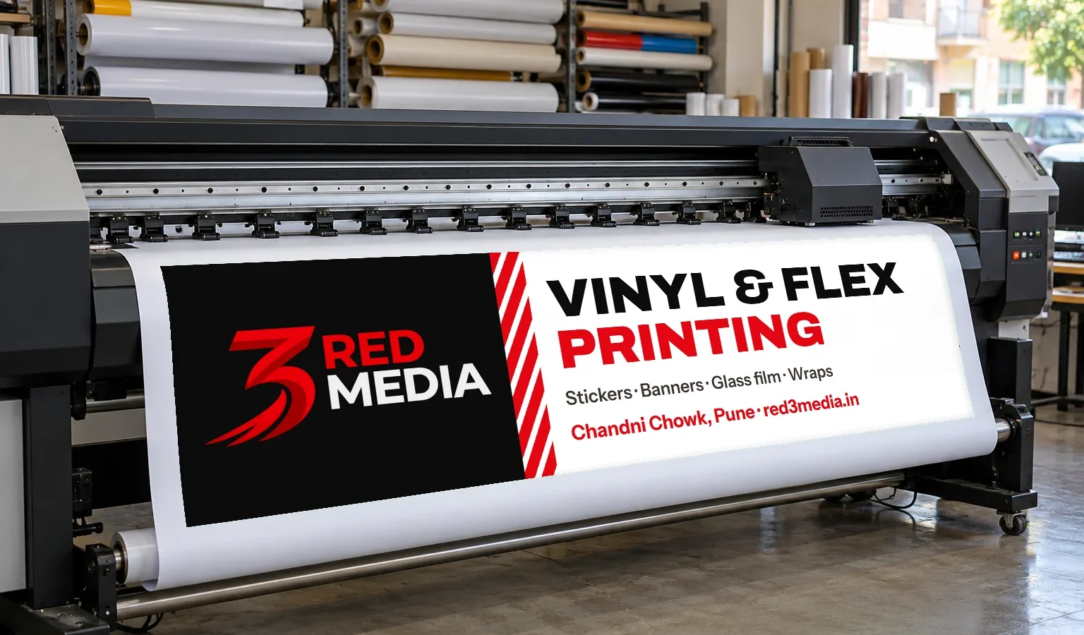 Printed vinyl coming off a large-format printer at the 3 Red Media print unit