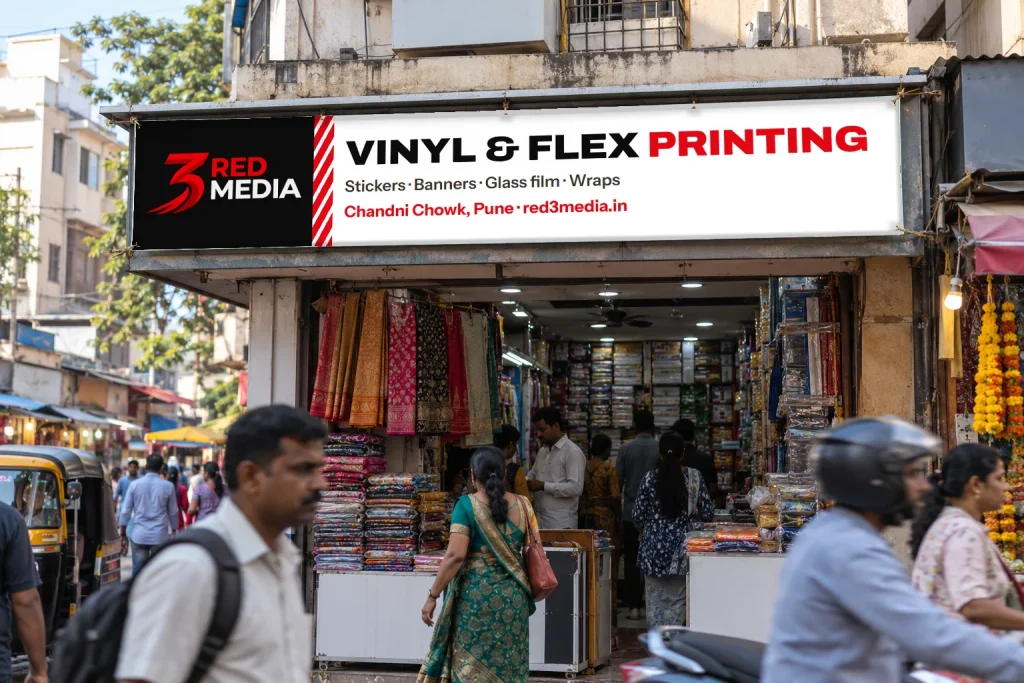 Printed vinyl banner with eyelets on a shop facade, advertising 3 Red Media